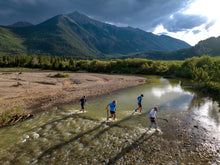 Load image into Gallery viewer, Leadville 100 runners cross a creek on the return trip to Leadville during the race near Twin Lakes. (Hugh Carey, The Colorado Sun)

